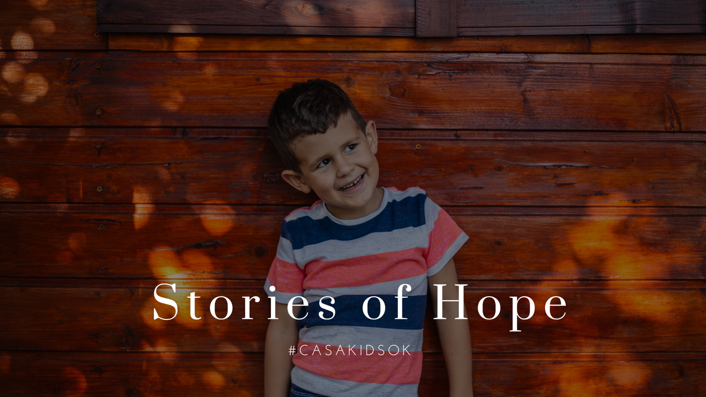 Stories of Hope. Young boy next to a wood wall. #casakidsok